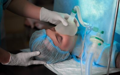 Female patient undergoing surgery Cropped shot of a nurse holding oxygen mask on a female patient during surgery medicine healthcare professionalism help concept.