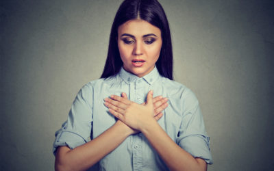 Young woman with asthma attack or respiratory problem Young woman with asthma attack or respiratory problem isolated on gray background